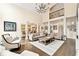 Elegant living room with high ceilings, a modern chandelier, and lots of seating at 100 Pine Mist Cir, Alpharetta, GA 30022