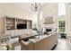 Spacious living room boasts high ceilings, large windows, and a beautiful fireplace at 100 Pine Mist Cir, Alpharetta, GA 30022