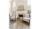 Bright living room featuring a fireplace, hardwood floors, and comfortable seating at 100 Pine Mist Cir, Alpharetta, GA 30022
