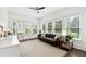 Bright living room features neutral tones, large windows, and a ceiling fan at 100 Pine Mist Cir, Alpharetta, GA 30022