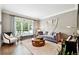 Cozy living room with hardwood floors, large windows, and stylish decor at 100 Pine Mist Cir, Alpharetta, GA 30022