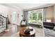 Bright and airy living room features hardwood floors and a large window with views of the front yard at 100 Pine Mist Cir, Alpharetta, GA 30022