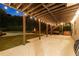 Covered outdoor patio features string lights, outdoor grill and spa overlooking the pool at 100 Pine Mist Cir, Alpharetta, GA 30022