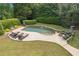 An aerial view of a private backyard oasis, featuring a custom pool, landscaping, and lounging area at 100 Pine Mist Cir, Alpharetta, GA 30022