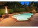 The kidney-shaped swimming pool is surrounded by manicured landscaping and ambient heat lamps at 100 Pine Mist Cir, Alpharetta, GA 30022