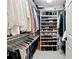 Well-organized walk-in closet with ample hanging space and shelving for shoes and accessories at 100 Pine Mist Cir, Alpharetta, GA 30022