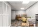 View of finished basement featuring wood-look floors, white door and closet, mini-fridge and a table set at 1019 Legacy Walk, Woodstock, GA 30189