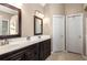 Bathroom featuring double sinks, dark wood cabinetry, and ample lighting at 1019 Legacy Walk, Woodstock, GA 30189
