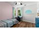 Bright bedroom with wood floors and a desk by the window at 1019 Legacy Walk, Woodstock, GA 30189