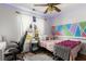 Bedroom with vibrant painted wall design and ample natural light from the window at 1019 Legacy Walk, Woodstock, GA 30189