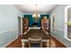 Bright dining room with a large wooden table, stylish chandelier, and classic millwork, perfect for hosting gatherings at 1019 Legacy Walk, Woodstock, GA 30189