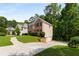 Lovely home with a well-kept lawn, driveway, and complemented by mature trees, providing a sense of tranquility and privacy at 1019 Legacy Walk, Woodstock, GA 30189