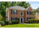 Inviting brick home featuring lush landscaping, a manicured lawn, and classic design elements, creating a warm and welcoming atmosphere at 1019 Legacy Walk, Woodstock, GA 30189