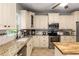 Updated kitchen featuring granite countertops, stainless steel appliances and custom cabinets at 1019 Legacy Walk, Woodstock, GA 30189