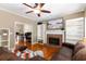 Inviting living room with fireplace and hardwood floors and open to office space at 1019 Legacy Walk, Woodstock, GA 30189