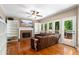 Bright living room boasts a fireplace, hardwood floors, ceiling fan and access to the back deck at 1019 Legacy Walk, Woodstock, GA 30189