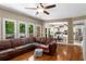 Open-concept living room with large windows, hardwood floors and access to the outdoor deck at 1019 Legacy Walk, Woodstock, GA 30189