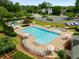 Community pool features a slide and ample seating with umbrella-shaded chairs, creating a resort-like atmosphere at 1019 Legacy Walk, Woodstock, GA 30189