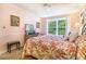 Charming bedroom with a floral bedspread, a window offering green views, and soft pink walls at 2505 Northlake Court Northeast, Atlanta, GA 30345