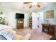 Spacious bedroom with a ceiling fan, soft carpet, and a view to the bathroom at 2505 Northlake Court Northeast, Atlanta, GA 30345