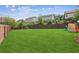 Wide open backyard featuring a wooden fence, green grass, and mature trees at 4020 Huron Dr, Cumming, GA 30028
