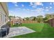 Large back yard featuring a patio area, wooden fence, and green grass at 4020 Huron Dr, Cumming, GA 30028