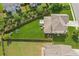 Aerial view of fenced backyard with lush green lawn, playset, patio and mature trees at 4020 Huron Dr, Cumming, GA 30028