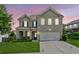 Charming two-story home featuring brick facade, manicured lawn, and an attached two-car garage at 4020 Huron Dr, Cumming, GA 30028