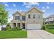 Charming two-story home with a well-manicured lawn, brick facade, and attached two-car garage at 4020 Huron Dr, Cumming, GA 30028