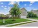 Beautiful two-story home with a brick facade, mature tree, and well-kept lawn at 4020 Huron Dr, Cumming, GA 30028