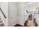 Bright hallway with white trim, wood floors, leading to staircase and the kitchen at 4020 Huron Dr, Cumming, GA 30028