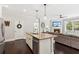 Open-concept kitchen, granite island, and view of the living room with a cozy fireplace at 4020 Huron Dr, Cumming, GA 30028
