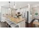 Bright kitchen featuring an island with bar seating, granite countertops, and stainless appliances at 4020 Huron Dr, Cumming, GA 30028