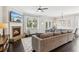 Living room featuring fireplace, TV, ceiling fan, and view into the dining area at 4020 Huron Dr, Cumming, GA 30028