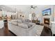 Open-concept living room with modern kitchen, fireplace, and comfortable gray sectional sofa at 4020 Huron Dr, Cumming, GA 30028