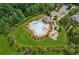 Aerial view of community pool, playground, and outdoor amenities surrounded by trees at 4020 Huron Dr, Cumming, GA 30028