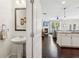 View from powder room into the living space with fireplace, kitchen, and open floor plan at 4020 Huron Dr, Cumming, GA 30028