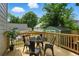 Cozy back deck with round table and chairs surrounded by green foliage, a perfect space for enjoying meals at 683 Terry Se St, Atlanta, GA 30315