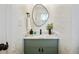 Elegant powder room featuring leaf-patterned wallpaper, a modern vanity with marble countertop, and stylish fixtures at 683 Terry Se St, Atlanta, GA 30315