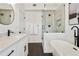 Bathroom featuring a glass-enclosed shower, a soaking tub, a single vanity, and sleek, modern fixtures at 683 Terry Se St, Atlanta, GA 30315