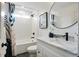 Bathroom featuring a bathtub with shower, marble countertop vanity and modern decor at 683 Terry Se St, Atlanta, GA 30315