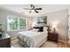 Well-lit bedroom with a queen-sized bed, ceiling fan, and a window offering tree views at 683 Terry Se St, Atlanta, GA 30315