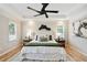 Serene main bedroom featuring a tray ceiling, hardwood floors, and stylish decor with a seating area at 683 Terry Se St, Atlanta, GA 30315