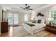Bright bedroom with a king-size bed, ceiling fan, and access to a private outdoor space at 683 Terry Se St, Atlanta, GA 30315
