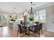 Stylish dining room with modern chandelier, light-filled windows, and an adjacent kitchen with breakfast bar at 683 Terry Se St, Atlanta, GA 30315