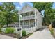 Inviting two-story home with a double balcony, lush landscaping, and a charming white picket fence at 683 Terry Se St, Atlanta, GA 30315