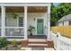 Charming front porch featuring brick steps, a green front door, and a classic white picket fence at 683 Terry Se St, Atlanta, GA 30315