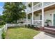 Charming home exterior featuring a lush front lawn, landscaped garden beds, and a quaint picket fence at 683 Terry Se St, Atlanta, GA 30315