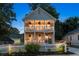 Charming two-story home with double porches illuminated by soft lighting, creating a welcoming ambiance at 683 Terry Se St, Atlanta, GA 30315