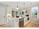 Bright kitchen featuring an island, stainless steel appliances, and sleek white cabinetry at 683 Terry Se St, Atlanta, GA 30315